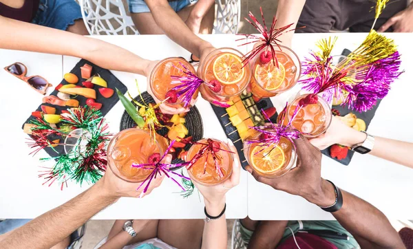 Friends hands toasting " Sex on the Beach " fancy drinks - Young people having fun together drinking cocktails at happy hour with fruit snacks buffet - Summer party time concept on bright vivid filter — Stock Photo, Image