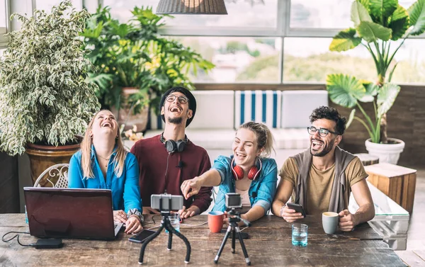 Young millenial friends sharing creative content online - Digital marketing concept with next generation influencer having fun on air with radio video stream - Vlogging time at startup coworking space — Stock Photo, Image
