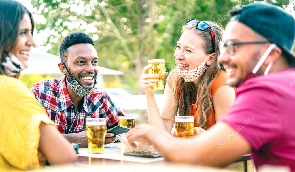 Friends drinking beer with opened face masks - New normal lifestyle concept with people having fun together talking on happy hour at brewery bar - Bright vivid filter with focus on afroamerican guy