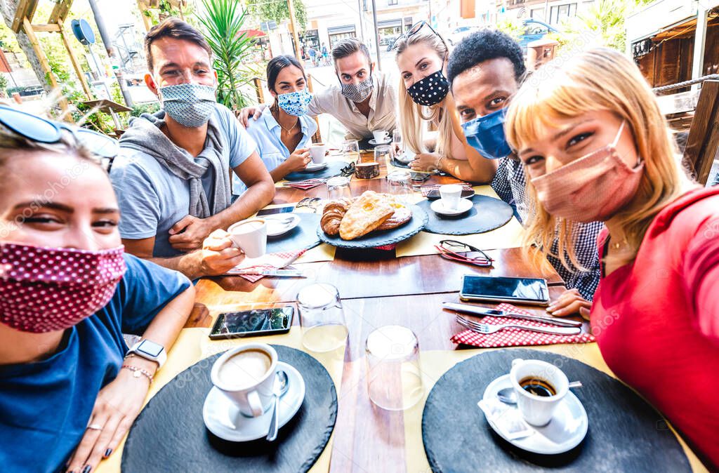 Friends taking selfie at coffee bar - People having fun together at cafeteria covered by face masks - New normal lifestyle concept with happy guys and girls at restaurant cafe - Bright vivid filter