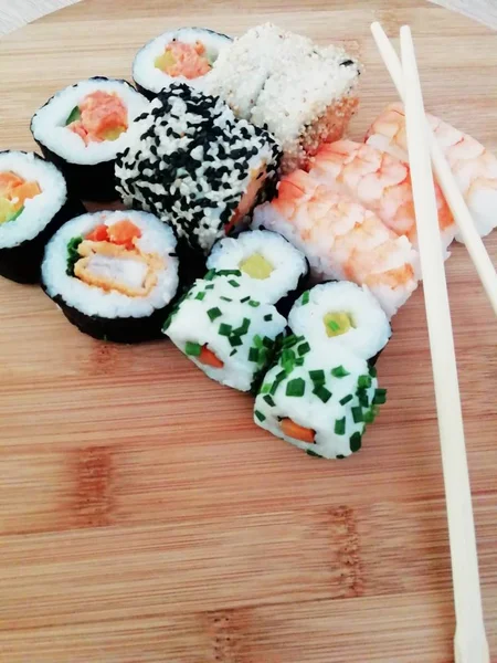 Comida de sushi. Maki y panecillos con atún, salmón, camarones, cangrejo y aguacate. Rollo de sushi arco iris, uramaki, hosomaki y nigiri . — Foto de Stock