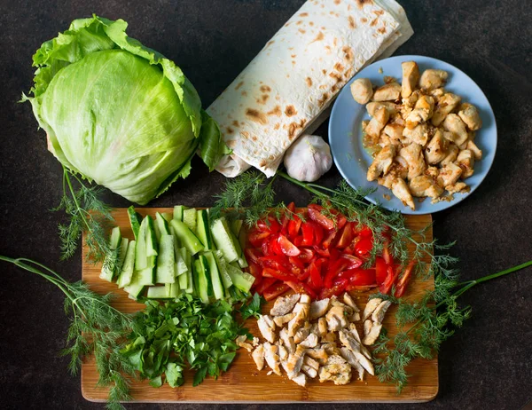 Yemek için malzemeler: salata, domates, salatalık, yeşillik, et, pide