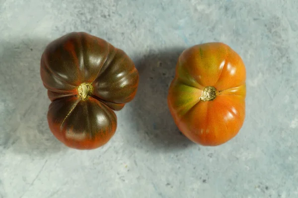 Two tomatoes of unusual shape. — Stock Image Two tomatoes of unusual shape. Stock Photo