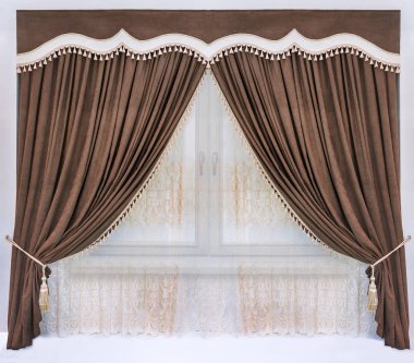 Decoration of the interior of the living room or bedroom in the classical, palace style. A brown curtain of the soft velvet fabric, a figured pelmet with an insert from a contrast material, and the transparent tulle with embroidery clipart