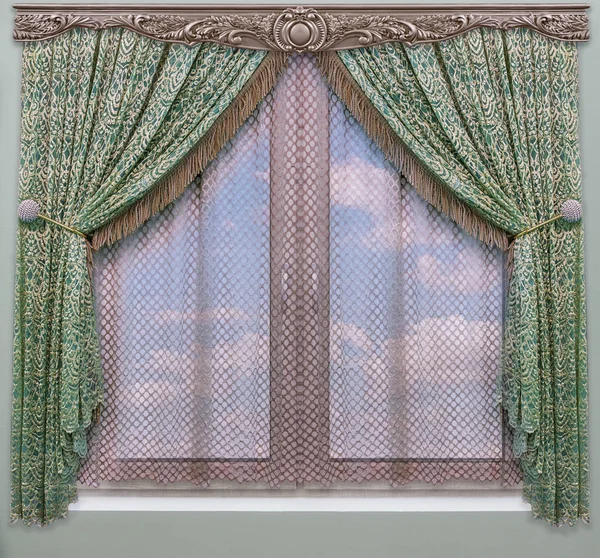 A green curtain with fringe of gold color hangs on a wooden carved cornice above the window overlooking a blue sky with clouds
