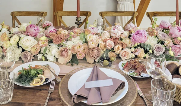 Стильный дизайн праздничный стол. Вкусные закуски, столовые приборы и декоративные цветы — стоковое фото