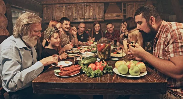 Friends Family Sitting Wooden Hunters Hut Having Dinner Table Full — Stock Photo, Image