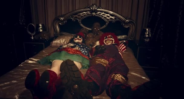 Two Scary Clowns Lying Together Bed — Stock Video