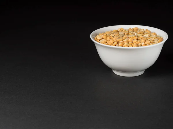 Dry yellow split peas on a black background. — Stock Image Dry yellow split peas on a black background. Royalty Free Stock Images