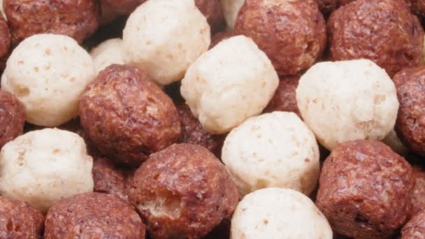 Dry breakfast. Corn balls close up. Chocolate and dairy. The balls are cereal. Delicious ingredient. — Stock Video