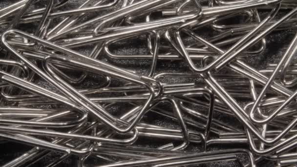 Paperclips stationery close-up. Metal consumables. — Stock Video