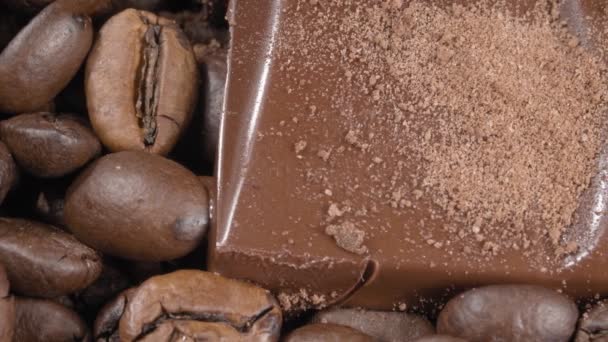 Coffee and chocolate close-up. Fried coffee beans and pieces of chocolate bar. Extreme macro. — Stock Video