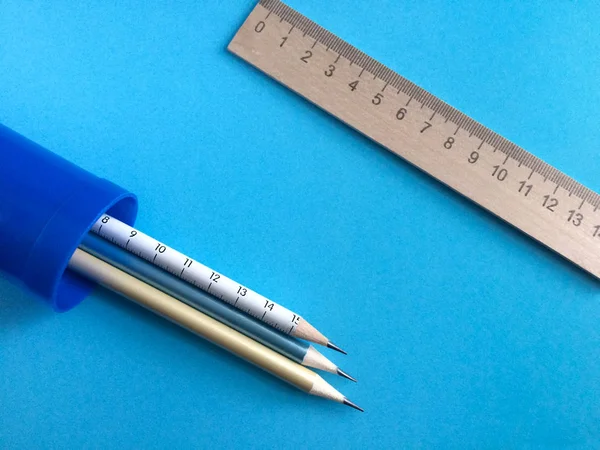 Stationery. Pencil case, pen, pencil, ruler on a blue background.