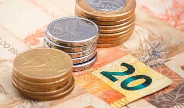 Brazilian Real banknotes and coins. Close up photography. Brazilian economy and finance concept.