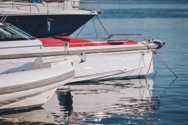 Brightly colored boats resting gently on calm waters in a serene harbor, inviting adventure and relaxation under the midday sun