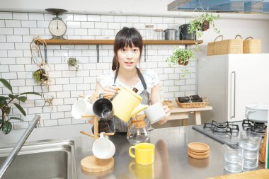 Genç bayan kahve yapıyor.