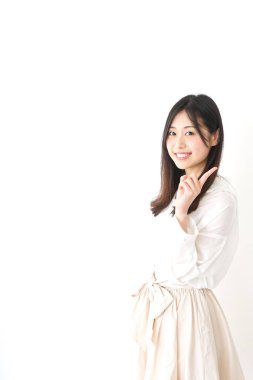 Güzel genç bir kadın bir şeyi işaret ediyor.