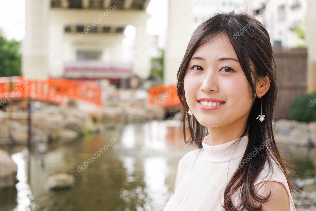 Young asian woman posing outdoors