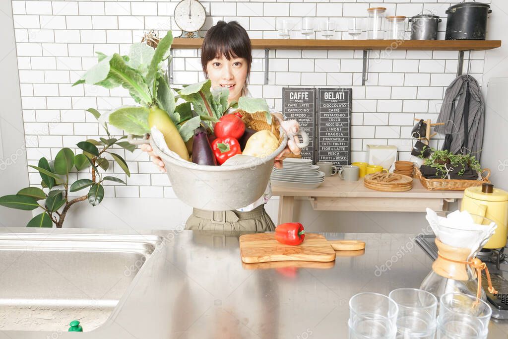young Asian woman cooking organic vegetables  