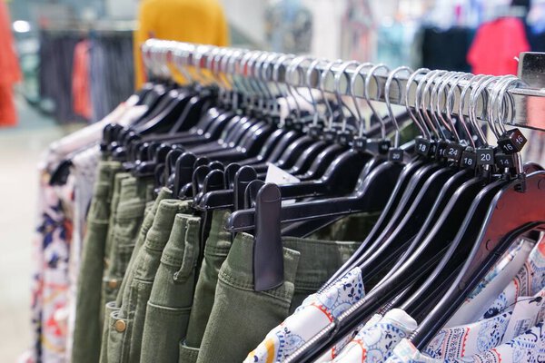 close-up shot of clothes hanging in shopping mall