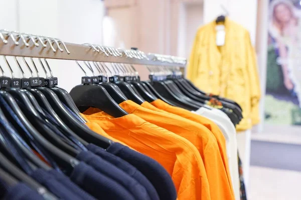 close-up shot of clothes hanging in shopping mall