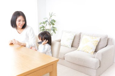 Anne ve çocuk birlikte telefondan arıyor.