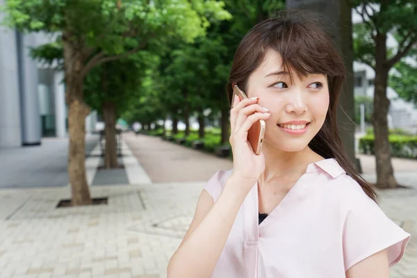 young asian woman phone calling on street