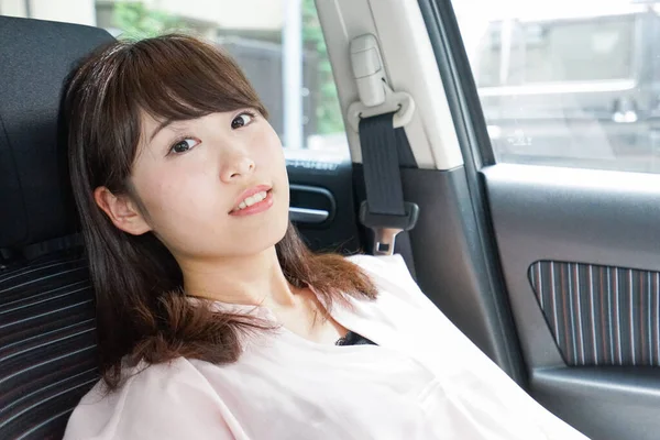 若いですアジアの女性は車で寝て — ストック写真