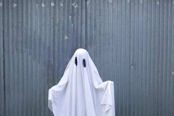 White ghost in front of a garage door — Stock Photo, Image