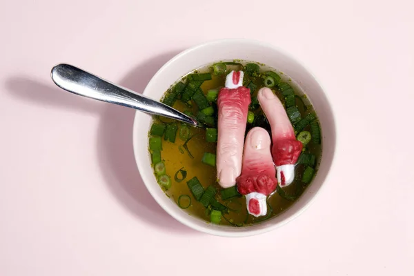 Fingers soup and spoon pink background — Stock Photo, Image