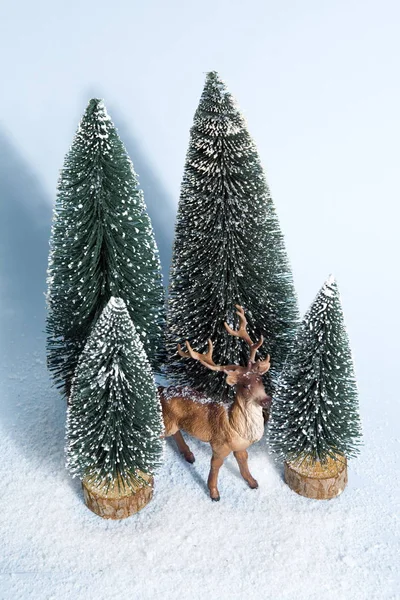 Snowy forest firs and reindeer blue — Stock Photo, Image