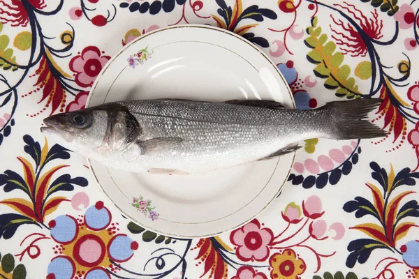 Bass fish inside a flower plate — Stock Photo, Image