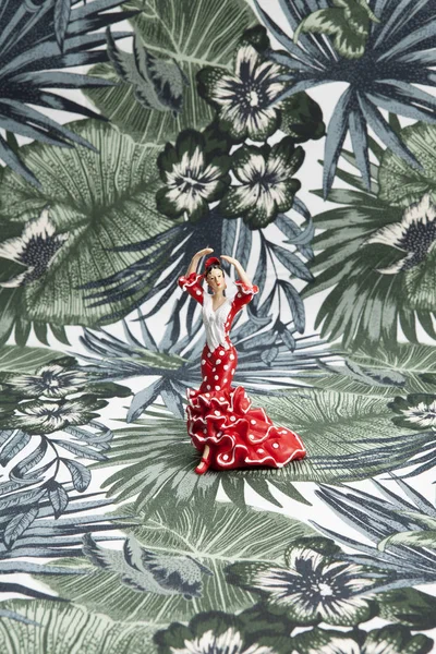 Flamenco dancer figurine on a tropical motif background Stock Image
