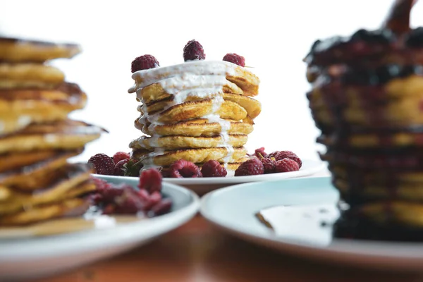 Pannkaka med rinnande yoghurt på en blå tallrik med hallon — Stockfoto