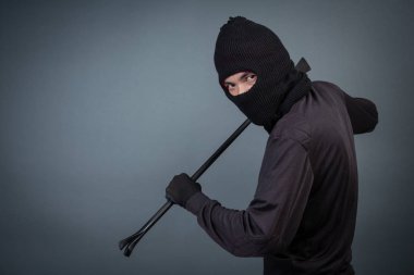 Black criminals wore a head yarn on a gray background.