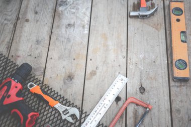 Construction tools placed on wooden floors.