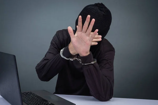 Thief Wearing Black Hat Obscuring Face Arrested Gray Background — Foto Stock