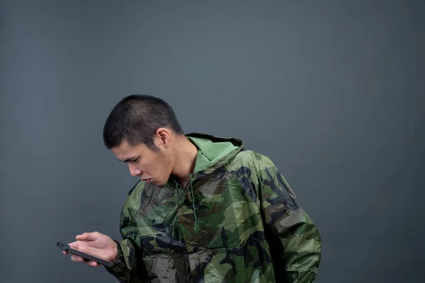Young Man Wears Camouflage Raincoat Shows Different Gestures Gray Background — Foto de Stock