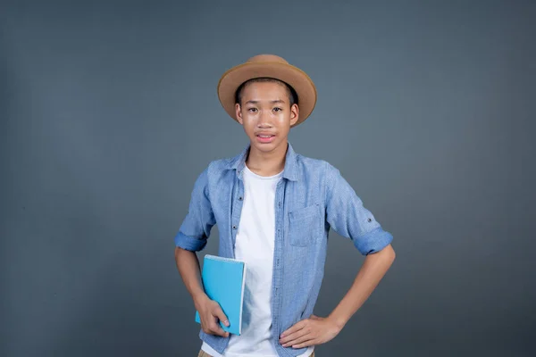 Teen Boy Wearing Blue Shirt Holding Book Gray Background — Stockfoto