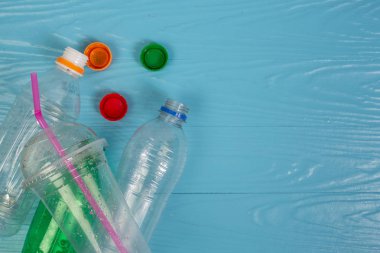 Placard bottles and bottle caps placed on a blue background.