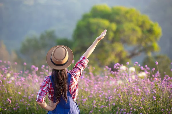 Young Farmer Admires Flowers Garden — 图库照片