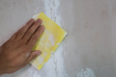 The painter who is painting in the house