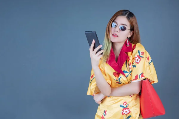 Women holding phones and smart cards.