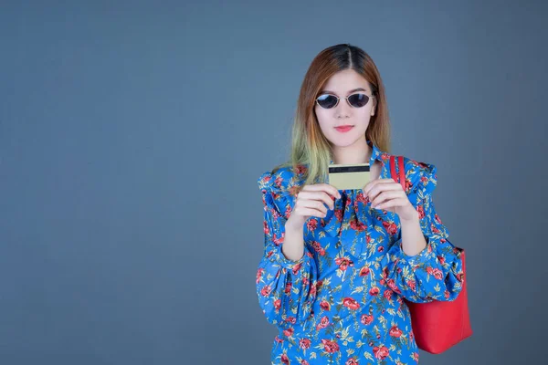 Women holding phones and smart cards.