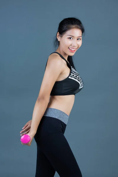 Women Fitness Wear Hold Dumbbells Gray Background — Stock fotografie