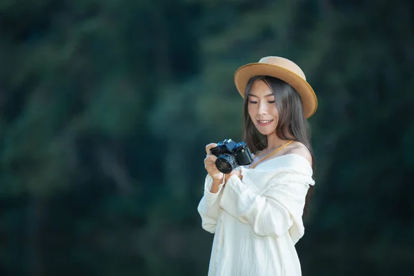 Female tourists who are taking photos of the atmosphere and smile happily.