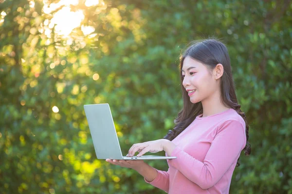 Women are selling products through social media using online notebooks at coffee shops.