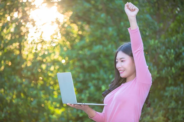 Women are selling products through social media using online notebooks at coffee shops.