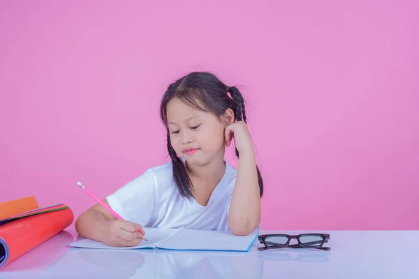 Girls write books on a pink background.