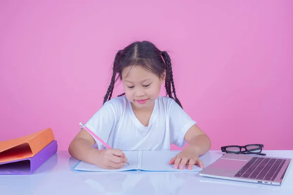 Girls write books on a pink background.